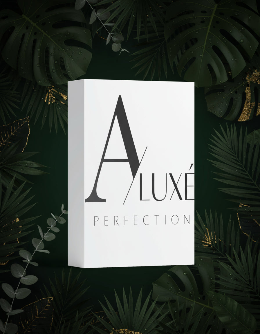 Skincare bottle with 'A'lux' branding on a white surface with greenery in the background
